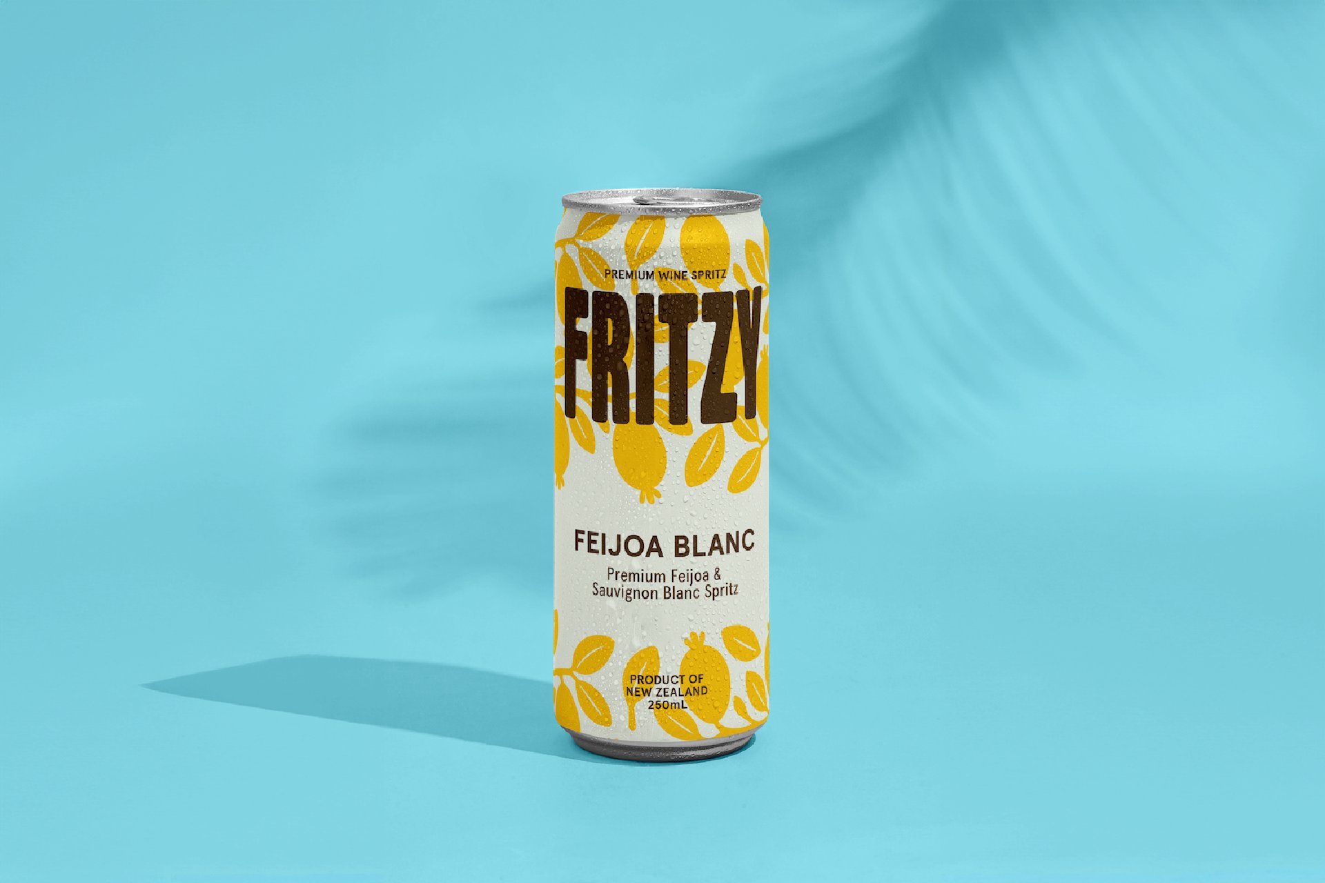 Fritzy Feijoa Blanc can - a premium wine spritz made with organic feijoas and Sauvignon Blanc, photographed against a bright blue background with palm leaf shadows